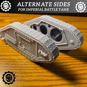 May include: Two gray model tank sides with the text "ALTERNATE SIDES FOR IMPERIAL BATTLE TANK". The tank sides have detailed track and hull features, including rivets and openings. The models are set on a wooden surface.