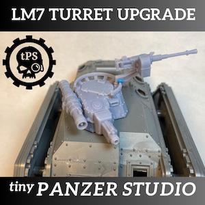 May include: A gray model tank with a turret upgrade. The text "LM7 TURRET UPGRADE" is at the top, and "tiny PANZER STUDIO" is at the bottom. A logo with a skull and crossbones is on the left.