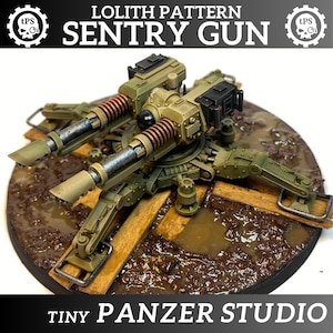 May include: A detailed model of a sentry gun, with dual barrels and intricate mechanical components. The model is painted in shades of green and brown, with copper-coloured springs. The base is a circular platform with wooden planks and a muddy texture. Text on the image reads "LOLITH PATTERN SENTRY GUN" and "TINY PANZER STUDIO."