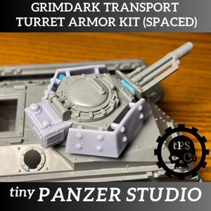May include: A gray Grimdark Transport Turret Armor Kit (Spaced) with a gun turret and a hatch. The text "tiny PANZER STUDIO" is at the bottom. The image also includes the text "GRIMDARK TRANSPORT TURRET ARMOR KIT (SPACED)".