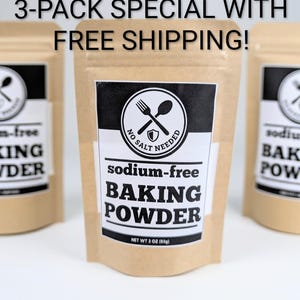May include: Three pouches of sodium-free baking powder. Each pouch is tan with a white label featuring a fork and spoon logo and the words "sodium-free BAKING POWDER." The net weight is 3 oz (85g). The text "3-PACK SPECIAL WITH FREE SHIPPING!" is at the top.