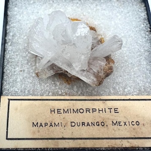 May include: A set of three ceramic mugs with a speckled, matte finish. The mugs are in shades of cream, light gray, and dark gray. Each mug has a simple, minimalist design, perfect for coffee or tea.