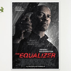 May include: A framed movie poster for "The Equalizer" featuring Denzel Washington. The poster is predominantly black and white, with Washington holding a gun in the rain. Text includes "What do you see when you look at me?" and "In Theaters September 26."