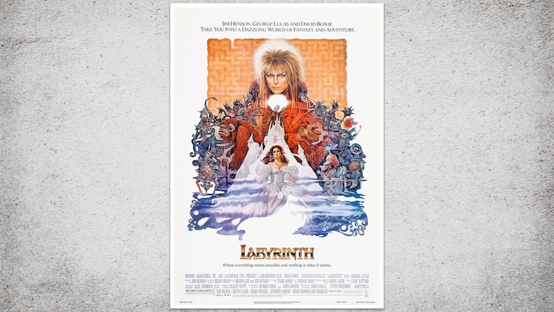 May include: A vintage movie poster for the film "Labyrinth" featuring David Bowie. The poster has a fantasy theme with a maze background and various characters. Text at the top reads "Jim Henson, George Lucas and David Bowie". The title "Labyrinth" is prominently displayed.