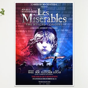 Peut inclure: Affiche de "Les Misérables: The Staged Concert" avec un visage central sur fond rouge et bleu. Le titre est en grandes lettres stylisées. Le poster inclut les noms des acteurs et la date de sortie au cinéma.