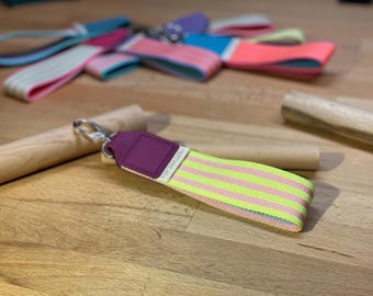 Colorful key lanyard made of durable yellow-pink webbing – with raspberry-colored leather end, carabiner & key ring