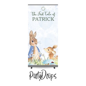 May include: A blue and white backdrop with a watercolour illustration of Peter Rabbit and a fawn. The text "The First Tale of PATRICK" is at the top of the backdrop.
