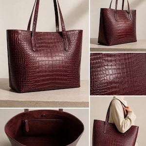 May include: A deep burgundy tote bag featuring a textured crocodile-embossed pattern. The bag has two shoulder straps, a spacious open interior with a single zippered pocket, and a magnetic snap closure at the top center of the main compartment.