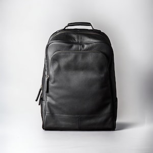 May include: A black leather backpack with a top handle and zippered pockets.