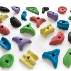 May include: A collection of colorful climbing holds in various shapes and sizes. The holds are made of a textured plastic and have a hole in the center for attaching to a climbing wall.