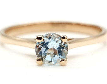 14 karat rose gold solitaire ring with blue topaz. unisex ring