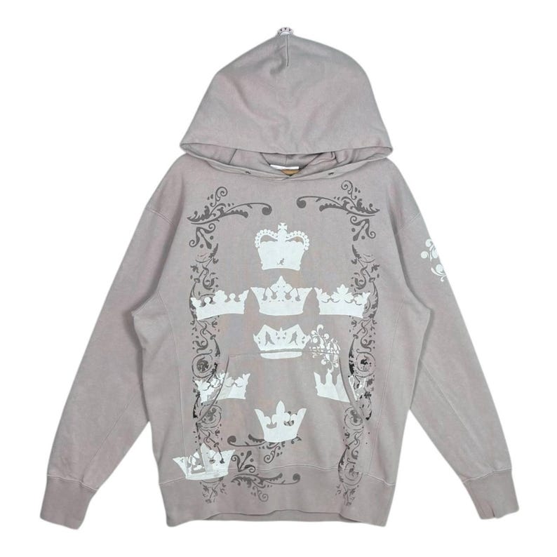 May include: A white ceramic mug with a black handle and the text "But First, Coffee" in a bold, black font. The mug is set against a blurred background, highlighting its clean design.