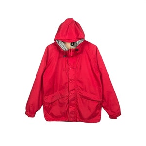 May include: A red hooded jacket with a zip and button fastening. The jacket has two pockets on the front and a drawstring hood.