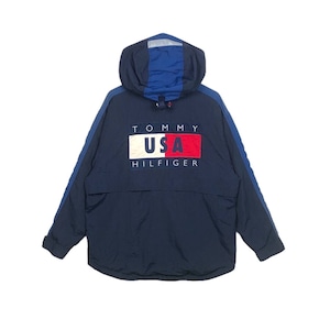 May include: A navy blue hooded jacket with a Tommy Hilfiger logo featuring the words "Tommy USA Hilfiger" and a red, white, and blue flag design.