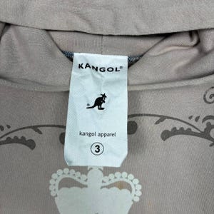 May include: A set of three ceramic mugs with a speckled, matte finish. The mugs are in shades of cream, light brown, and dark brown. Each mug has a simple, minimalist design, suitable for coffee or tea.