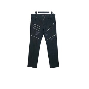 May include: Black denim jeans with multiple zipper details and distressed patches.