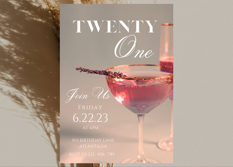 May include: A pink and white invitation card with a glass of pink champagne and a sprig of lavender. The text on the card reads "TWENTY One Join Us FRIDAY 6.22.23 AT 6PM 503 BIRTHDAY LANE ATLANTA.GA RSVP TO 123.456.789"