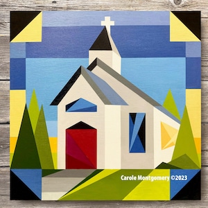 May include: A geometric painting of a white church with a red door, blue windows, and a gray roof. The church is surrounded by green trees and a yellow field. The painting is signed "Carole Montgomery ©2023".