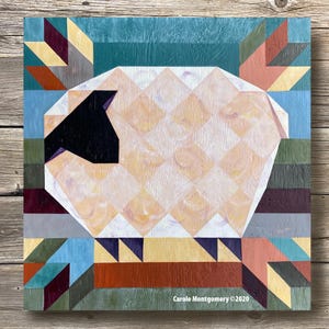 May include: A geometric abstract painting of a sheep with a black face, in shades of white, yellow, orange, red, blue, green, and brown. The painting is signed "Carole Montgomery © 2020".