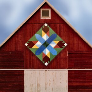 May include: A red barn with a large, colourful quilt pattern painted on the side. The pattern is a starburst design with shades of blue, green, yellow, and red.