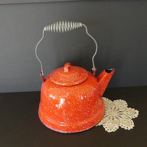 May include: A white ceramic mug with a black handle and the text "But First, Coffee" in a black, bold font. The mug is on a white surface.