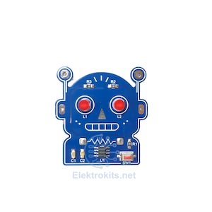 May include: A blue robot-shaped circuit board with red LED eyes and electronic components. The text "Elektrokits.net" is printed at the bottom. Ideal for electronics enthusiasts.