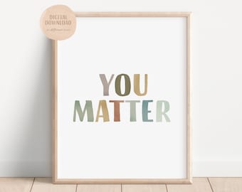 May include: A framed print with the text "YOU MATTER" in colorful, stylized letters. The letters are in shades of green, blue, brown, and yellow.