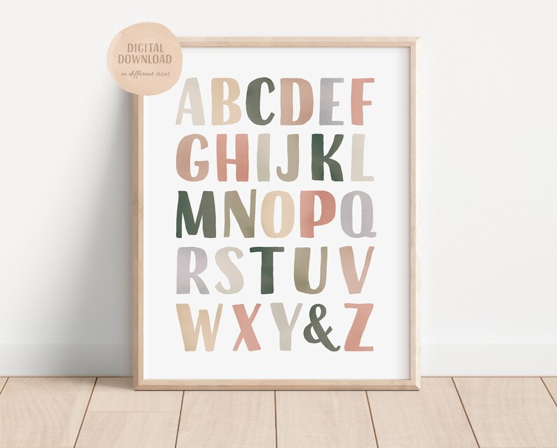 May include: A printable alphabet poster with letters in different colors and fonts. The letters are in shades of pink, green, brown, and gray. The letters are arranged in rows, with the first row being A-F, the second row being G-L, the third row being M-Q, the fourth row being R-V, and the fifth row being W-Z.