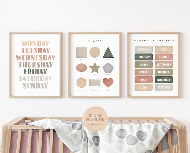 May include: Three printable posters with a watercolor background in shades of pink, green, and brown. The first poster lists the days of the week, the second poster shows basic shapes with their names, and the third poster lists the months of the year.