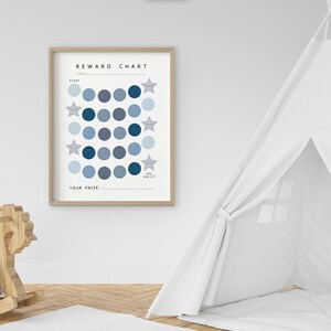 May include: A blue and white reward chart with a wooden frame. The chart has a grid of circles with stars in the corners. The text "REWARD CHART" is at the top of the chart. The text "YOU DID IT!" is at the bottom of the chart. The text "YOUR PRIZE" is below the grid of circles.