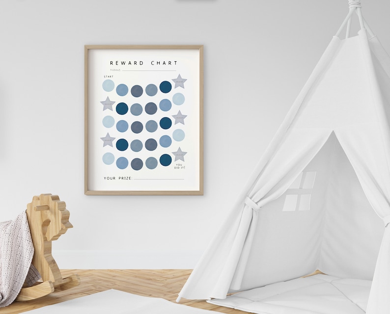May include: A blue and white reward chart with a wooden frame. The chart has a grid of circles with stars in the corners. The text "REWARD CHART" is at the top of the chart. The text "YOU DID IT!" is at the bottom of the chart. The text "YOUR PRIZE" is below the grid of circles.
