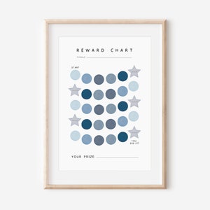 May include: A blue and white reward chart with a grid of circles and stars. The chart has the text "REWARD CHART" at the top and "YOU DID IT!" at the bottom. The chart is framed in a light wood frame.