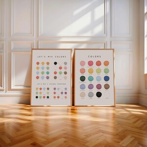 Neutral nursery decor with two framed color posters on floor near crib and soft sunlight