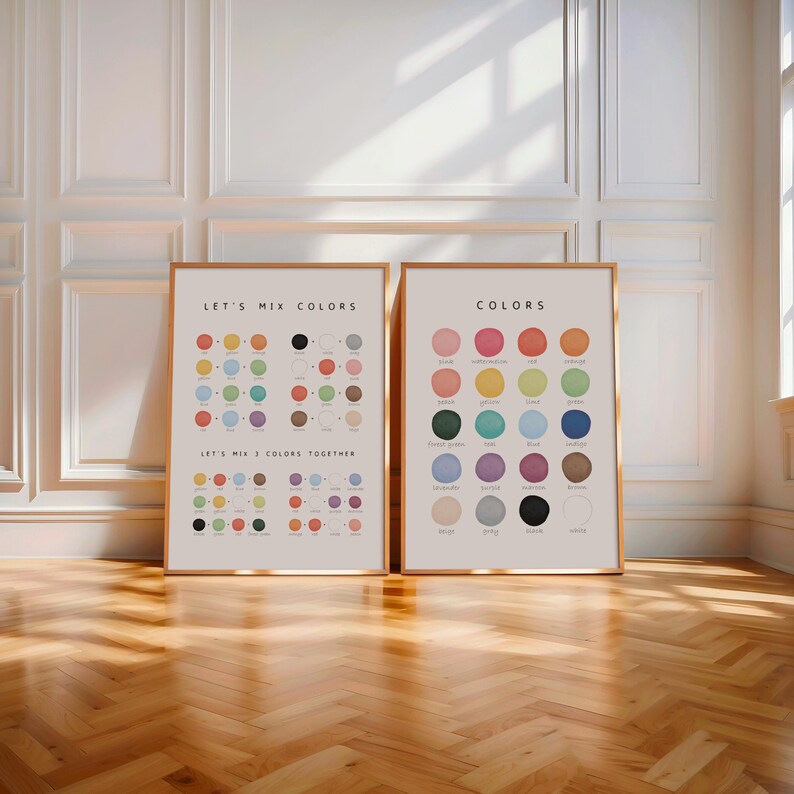 Neutral nursery decor with two framed color posters on floor near crib and soft sunlight