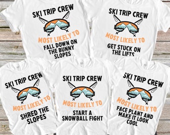May include: Four white t-shirts with a ski trip crew theme. Each shirt has a different graphic with text that says "Most Likely To" followed by a funny ski-related activity. The graphics feature a pair of ski goggles, mountains, and ski poles.