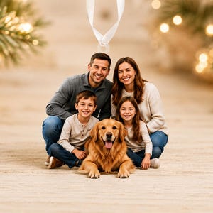 May include: A family portrait featuring two adults, a young boy, a young girl, and a golden retriever dog. The adults wear long-sleeved shirts and blue jeans, while the children wear light-colored long-sleeved shirts. The dog sits in the center.