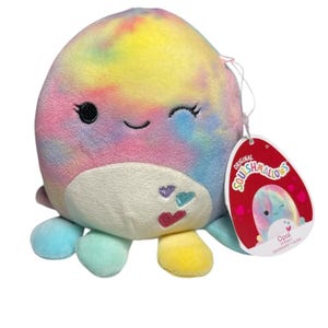 May include: A colorful plush octopus toy with a tie-dye pattern in shades of yellow, pink, blue, and green. The toy has a smiling face with a winking eye and small hearts on its belly. A red tag with the name "Opal" is attached.