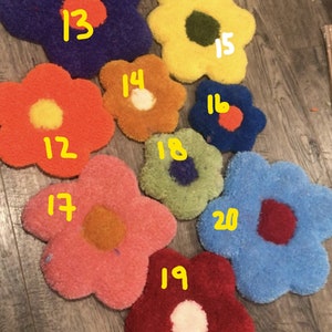 May include: Nine colorful flower-shaped rugs with different colored centers. The rugs are numbered 12 through 20.