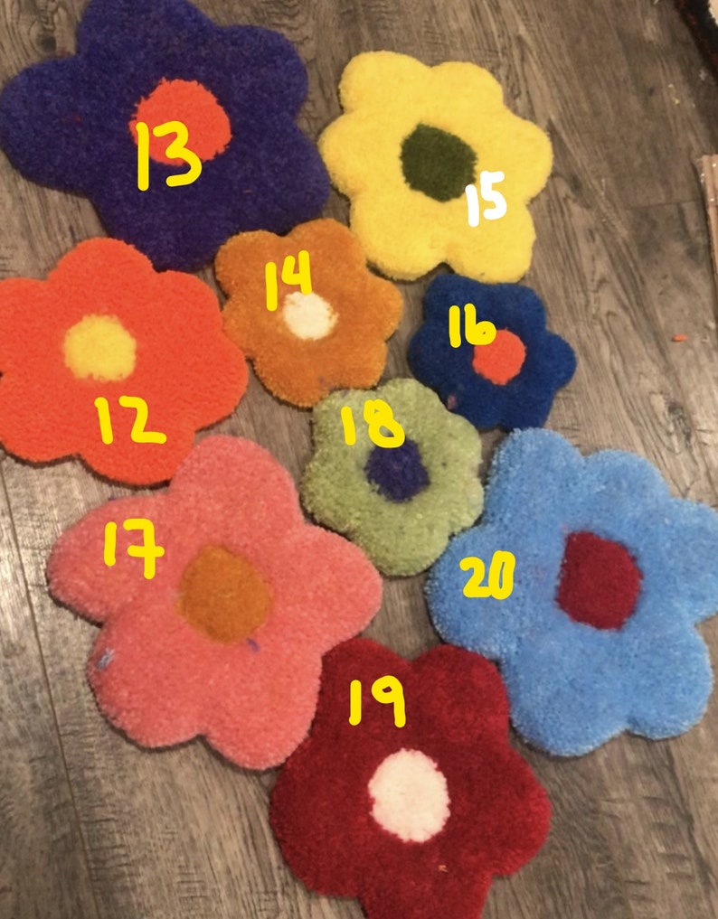 May include: Nine colorful flower-shaped rugs with different colored centers. The rugs are numbered 12 through 20.