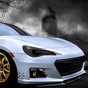 May include: A white sports car with black headlights and a black grille. The car is parked in front of a spooky background with trees and fog.