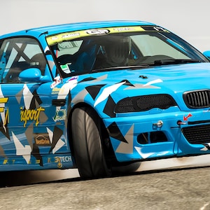 May include: A blue BMW M3 with a white and black camouflage pattern, the car is drifting and has smoke coming from the rear tires. The car has a black grill and black headlights. The car has a sticker on the side that says "PC import".