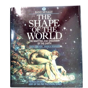 May include: A hardcover book titled "The Shape of the World" by Rand McNally. The cover features a starry night sky background with the title in large white letters. An illustration of a man measuring a map is on the bottom.