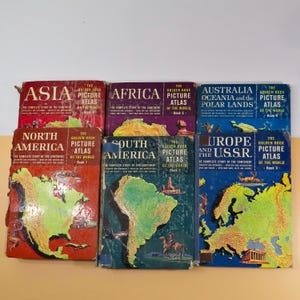 May include: A collection of six vintage hardcover books titled The Golden Book Picture Atlas of the World, featuring individual volumes for Asia, Africa, Australia, North America, South America, and Europe and the U.S.S.R. with colorful maps.
