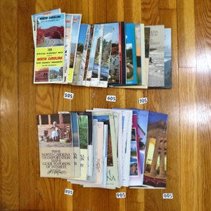 May include: A collection of vintage North Carolina travel maps and guides. The maps are from the 1950s, 1960s, 1970s, 1980s, and 1990s. The maps feature a variety of locations in North Carolina, including the Blue Ridge Mountains, the Outer Banks, and the Piedmont.
