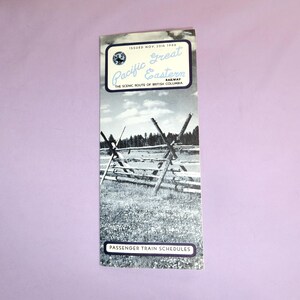 May include: A black and white photo of a wooden fence in a field. The image is from a vintage pamphlet for the Pacific Great Eastern Railway, issued in November 1960. The text reads "The Scenic Route of British Columbia" and "Passenger Train Schedules".