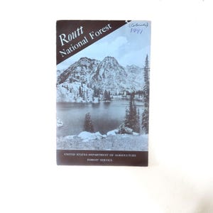 May include: Vintage Routt National Forest brochure from Colorado, 1941. The cover features a black and white landscape of a mountain range, lake, and trees. The brochure is from the United States Department of Agriculture, Forest Service.