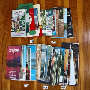 May include: A collection of vintage travel brochures for the state of Georgia. The brochures are organized by decade, with the 1950s, 1960s, 1970s, 1980s, and 1990s represented. The brochures feature images of Georgia's landmarks, scenery, and attractions.