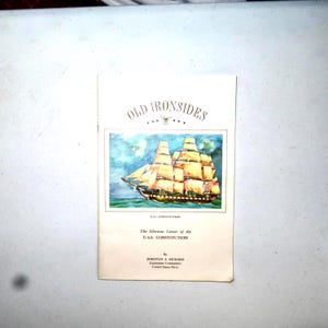 May include: A vintage booklet titled "Old Ironsides" featuring a watercolor painting of a tall ship. The cover includes the text "The Glorious Career of the U.S.S. Constitution" and the author's name, Dorothy E. Richard.