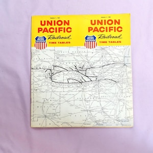May include: A black and white map of the United States showing the Union Pacific Railroad lines. The map is titled "Union Pacific Railroad Time Tables" and the date is January 1, 1963.