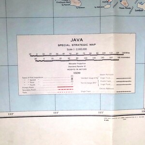 May include: A vintage map of Java, Indonesia, labeled "Special Strategic Map." The map includes a scale of 1:2,000,000, with measurements in miles and kilometers. It features a legend with symbols for towns, roads, and railroads.